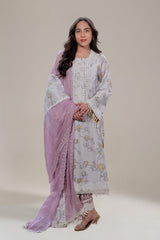 Woman wearing a floral dress with a pink dupatta