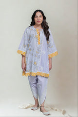 Woman wearing a light gray floral kurta with yellow accents